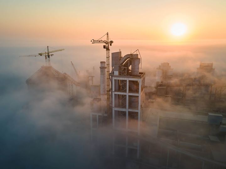 Aerial view of a cement factory in foggy sunrise